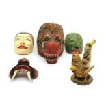 A collection of carved polychrome Balinese masks