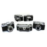 A collection of five film cameras,