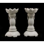 A pair of Chinese white-glazed candlesticks,