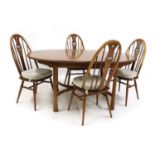 An Ercol elm dining suite,
