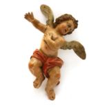 A carved polychrome figure of a putto,