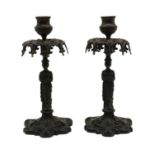 A pair of bronzed figural candlesticks