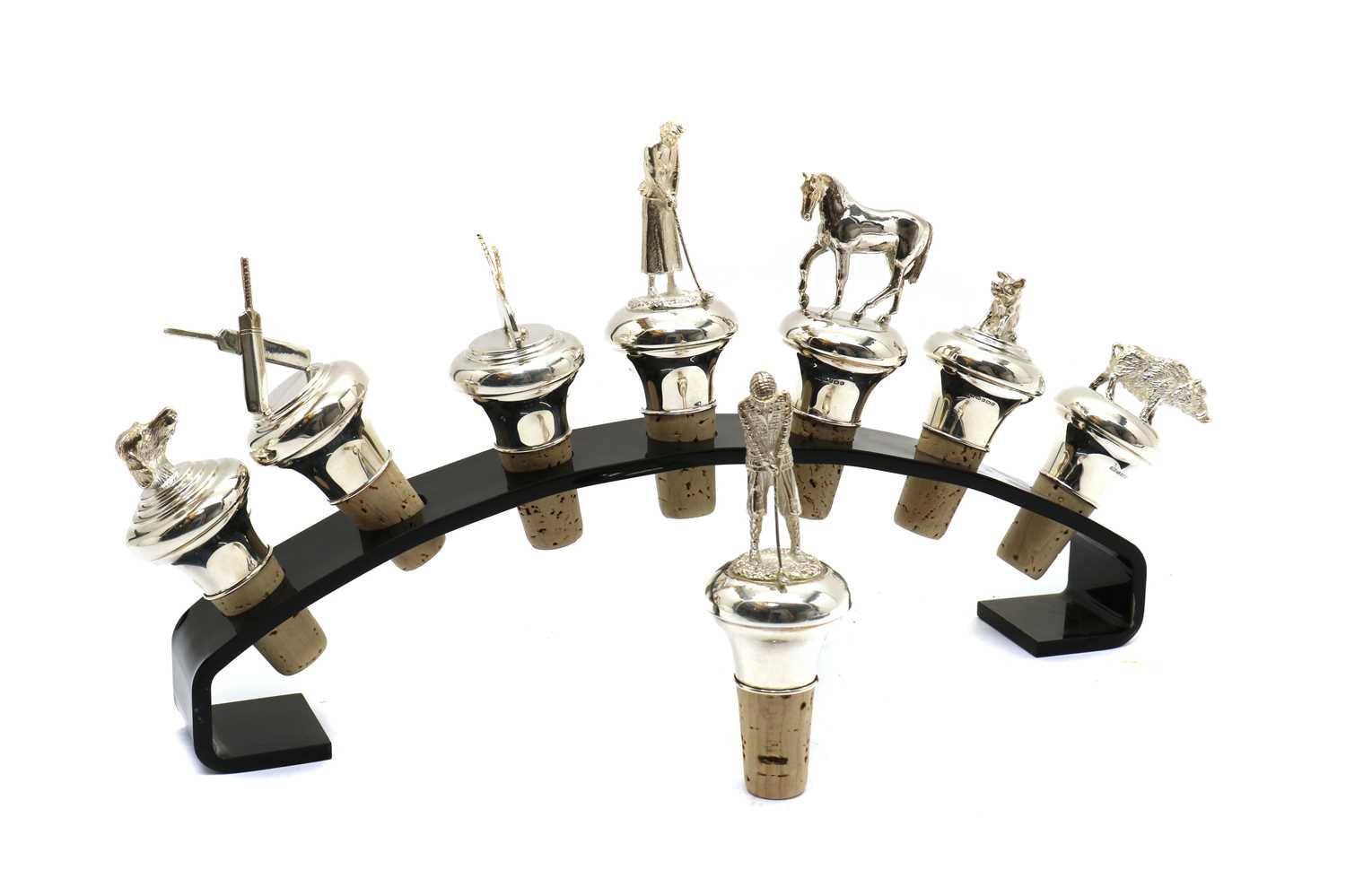 A group of eight modern silver novelty bottle stoppers,