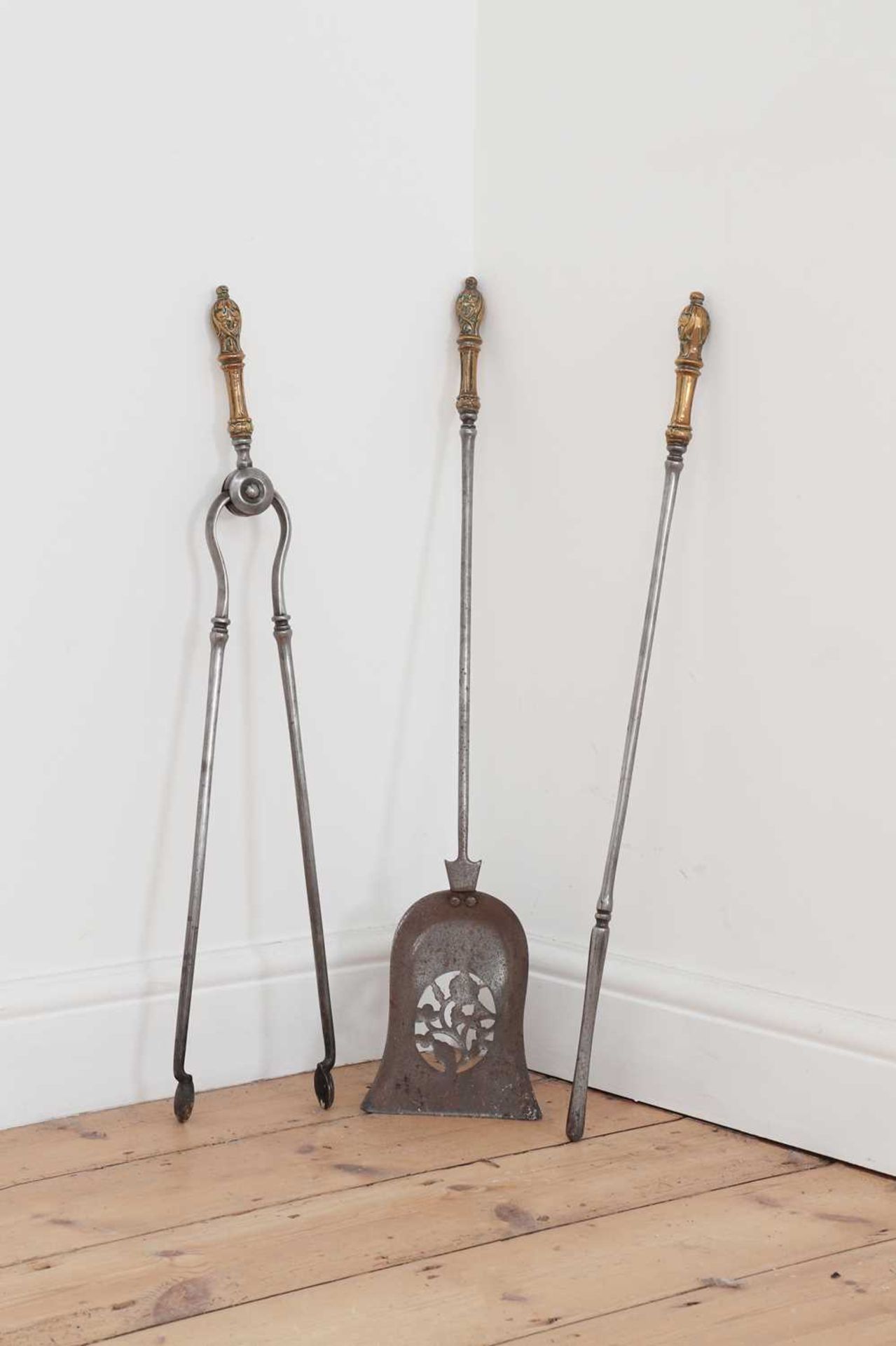A set of three George III steel and ormolu fire irons,