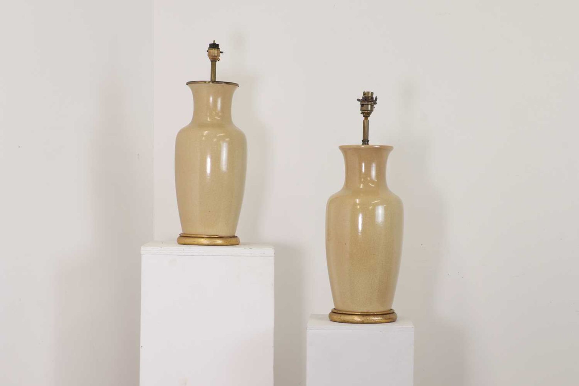 A pair of Chinese-style beige porcelain table lamps,