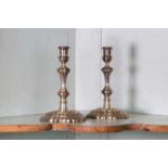 A pair of George II cast silver candlesticks,