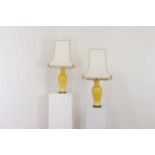 A pair of Chinese-style yellow porcelain table lamps,