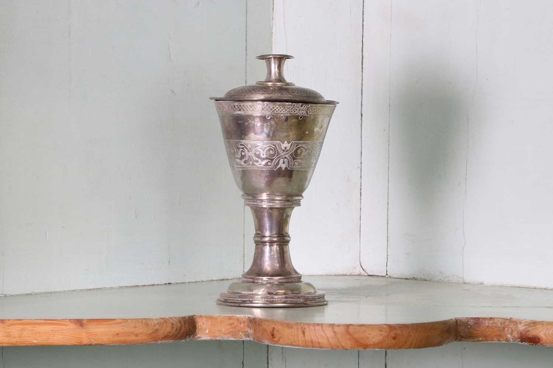 An unmarked silver communion cup and paten,