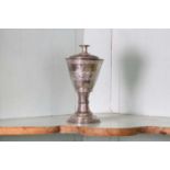 An unmarked silver communion cup and paten,