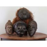 A collection of carved softwood African masks,