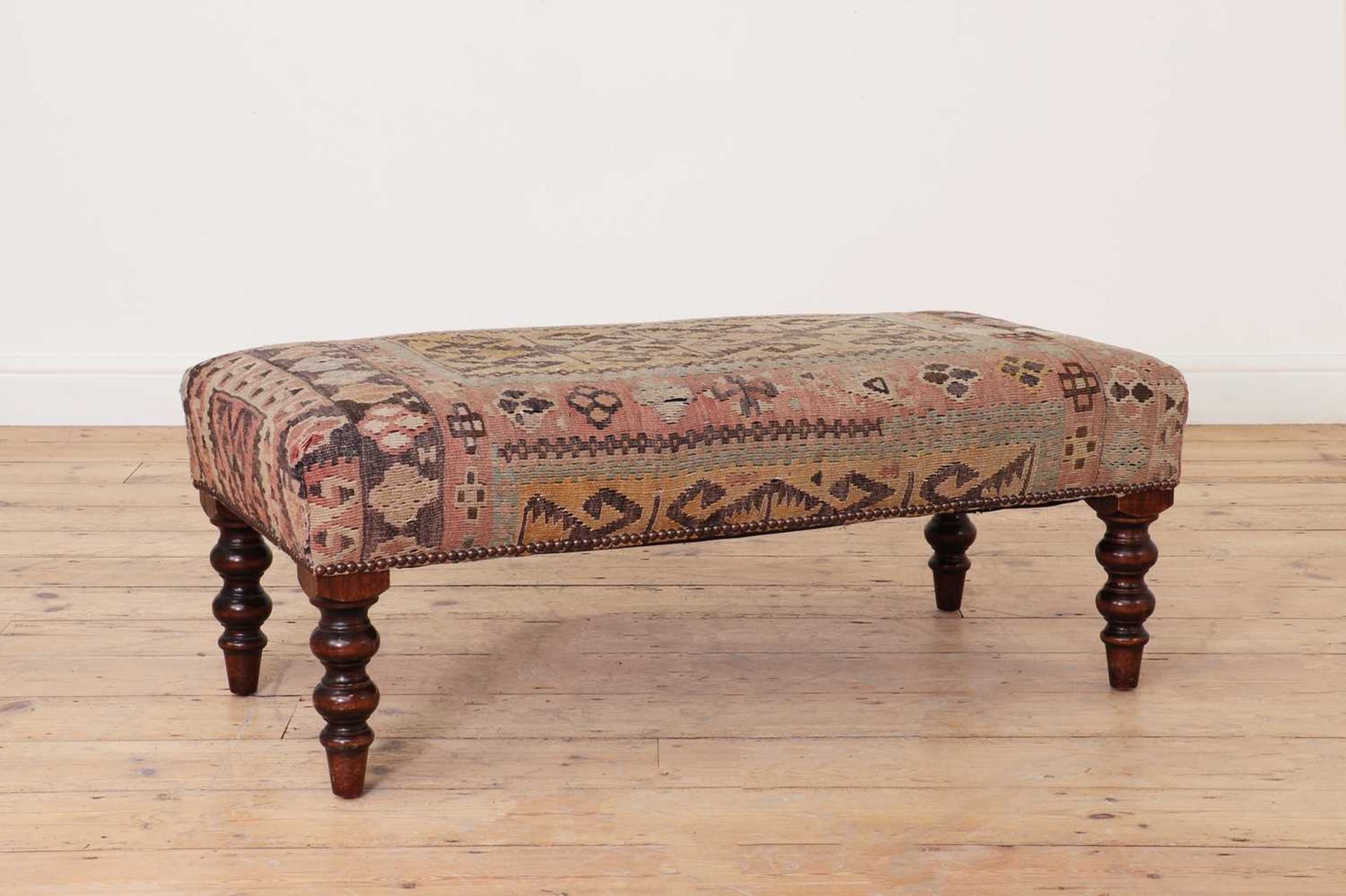 A kilim upholstered stool,