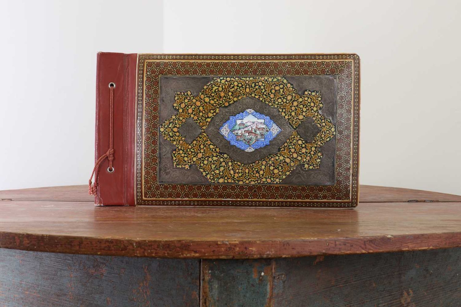 An inlaid, lacquered and silver-mounted photo album,