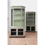A pair of green-painted shop vitrines,