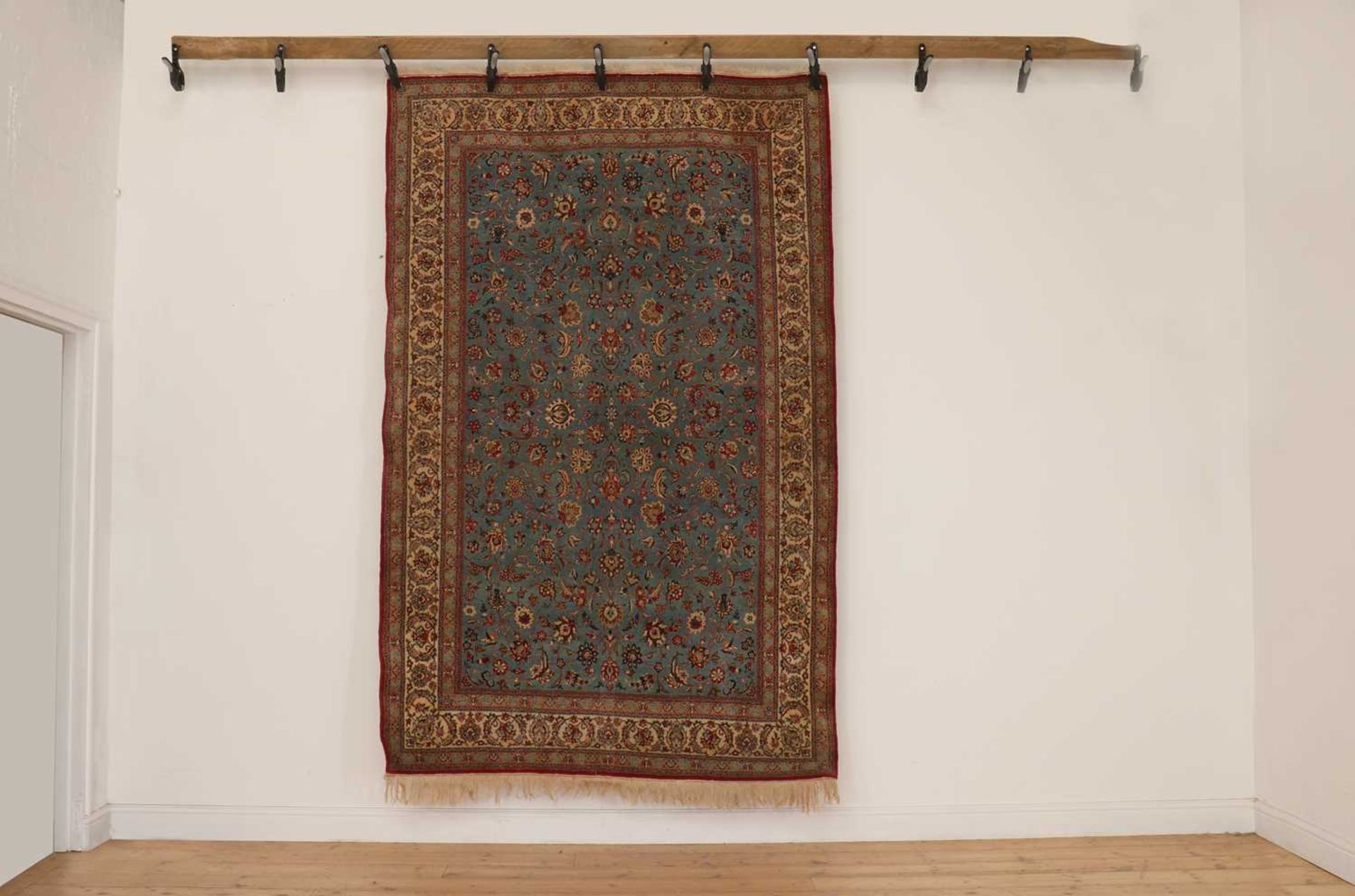 A Persian wool rug,