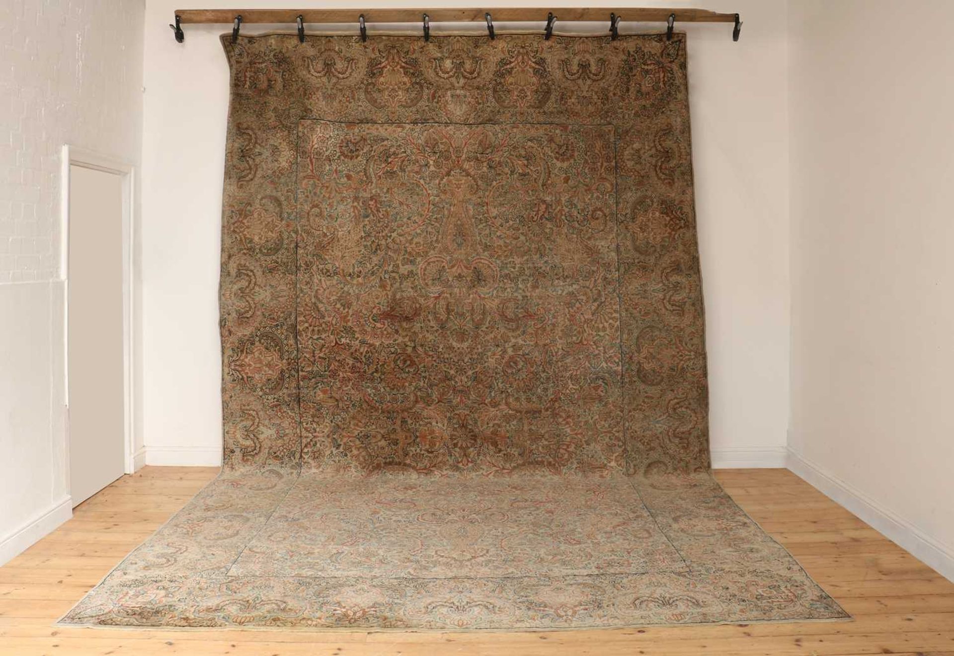 A large Persian wool carpet,