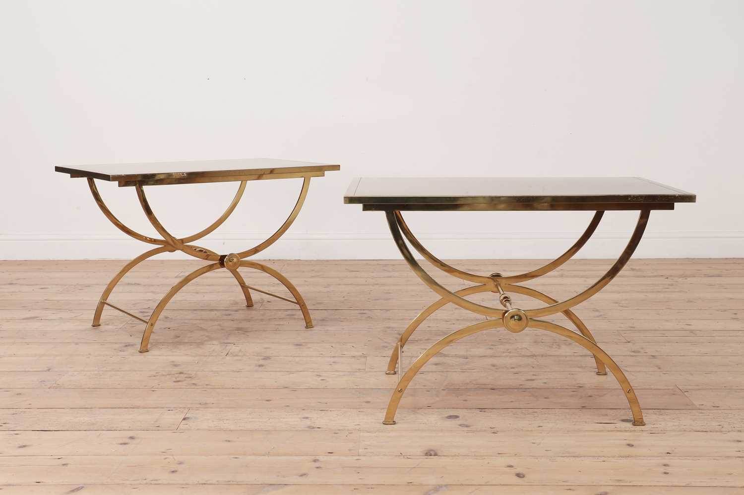 A pair of brass low side tables,