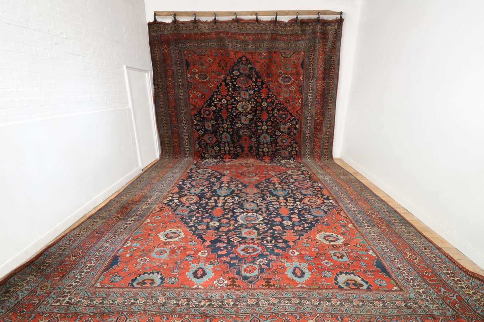 A large Persian wool carpet,