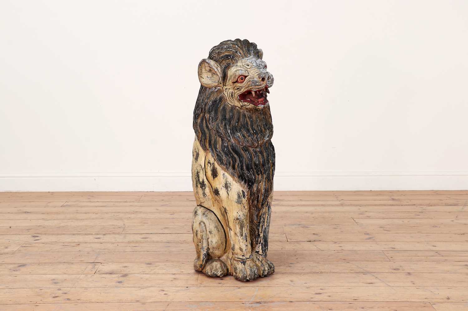 A large carved and painted wooden lion,