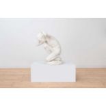 A marble figure of a crouching faun,