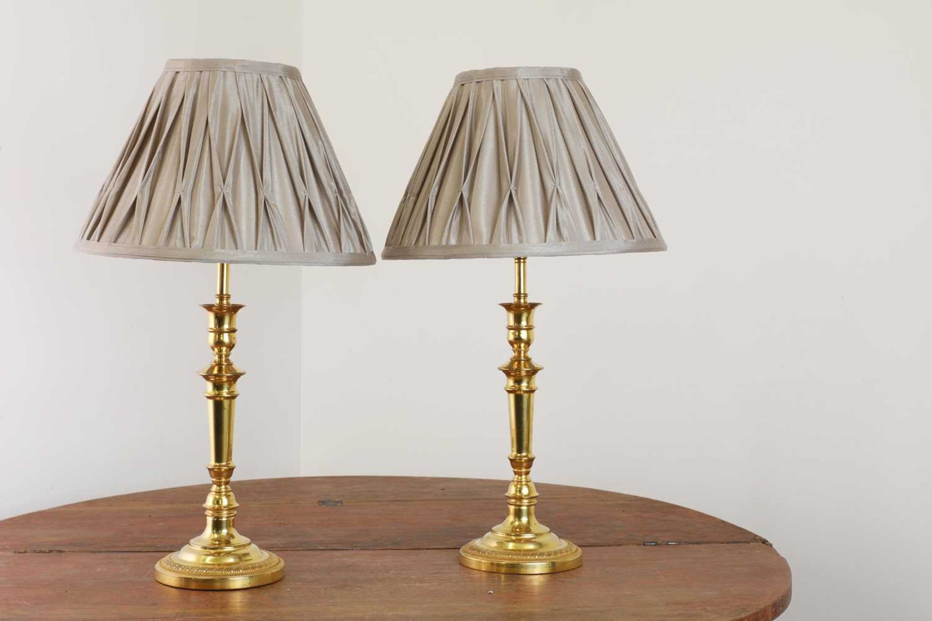 A pair of French Empire-style gilt-brass table lamps,
