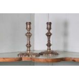 A pair of George II cast silver candlesticks,