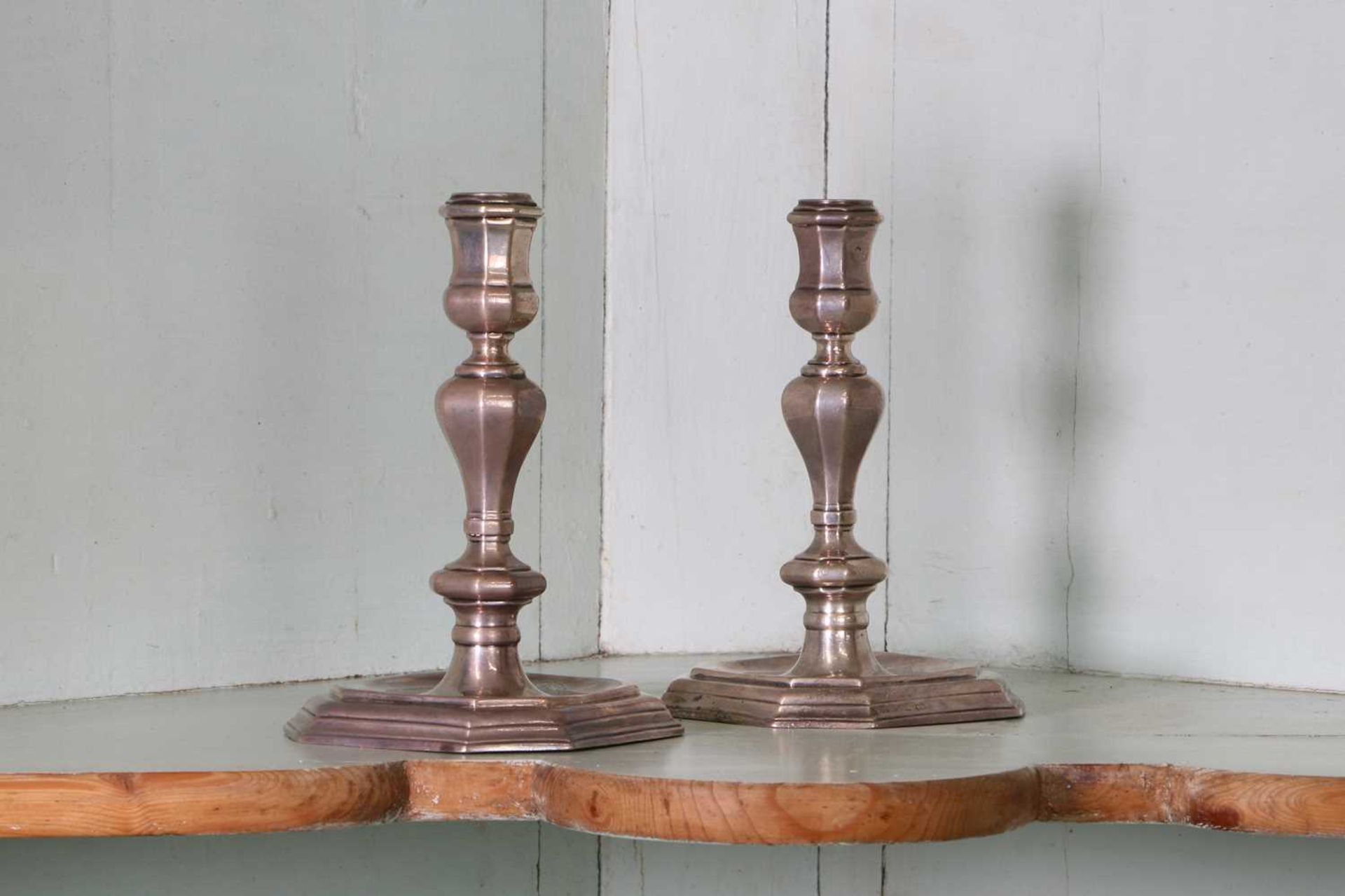 A pair of early 18th century Britannia silver candlesticks,