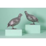 A pair of silver models of partridges,