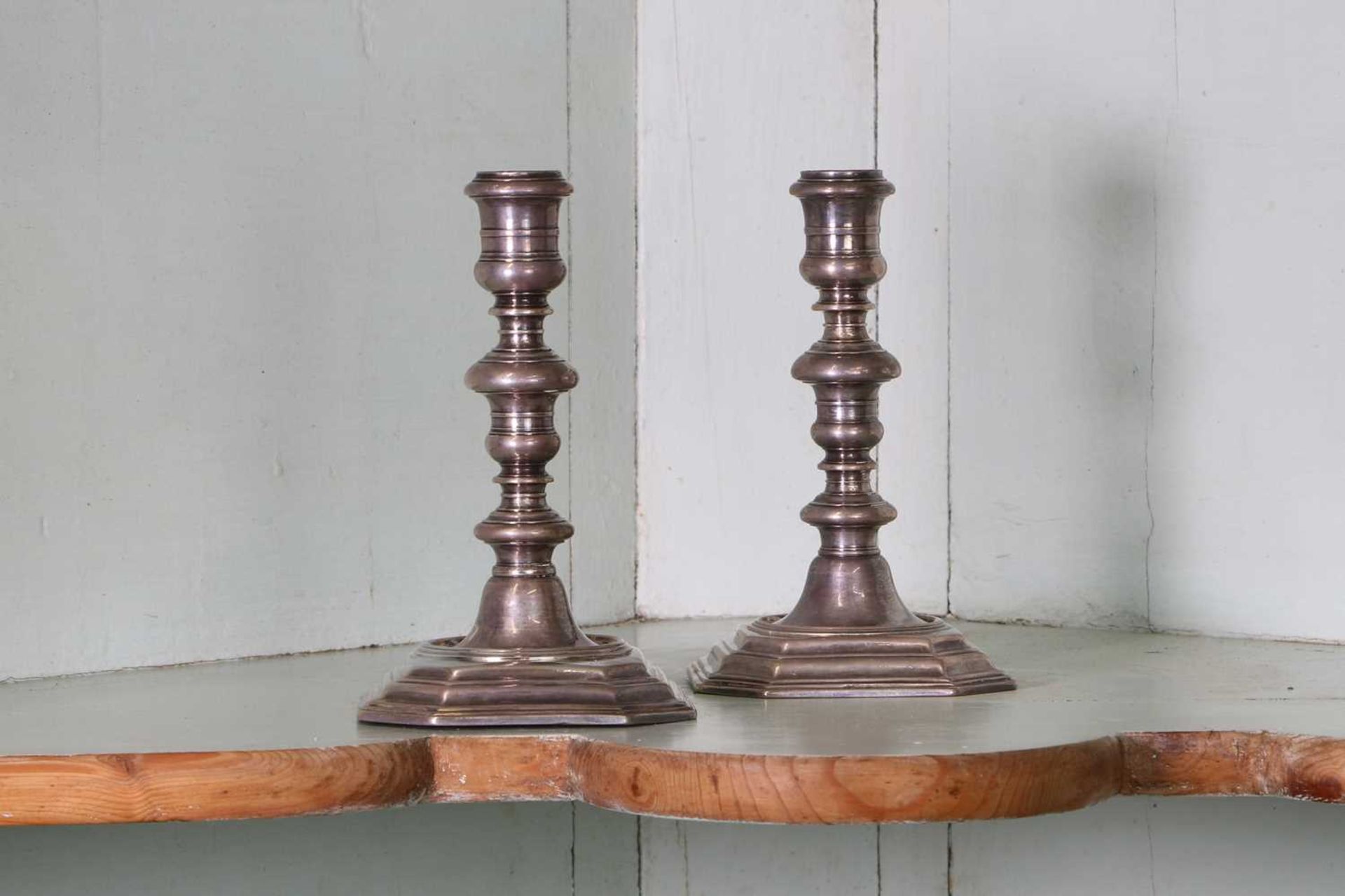 A pair of Queen Anne Britannia standard silver candlesticks,