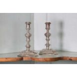 A pair of William III Britannia standard cast candlesticks,