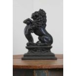 A cast iron doorstop as an heraldic lion,