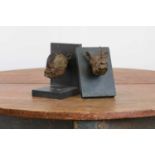 A pair of bronze bookends,
