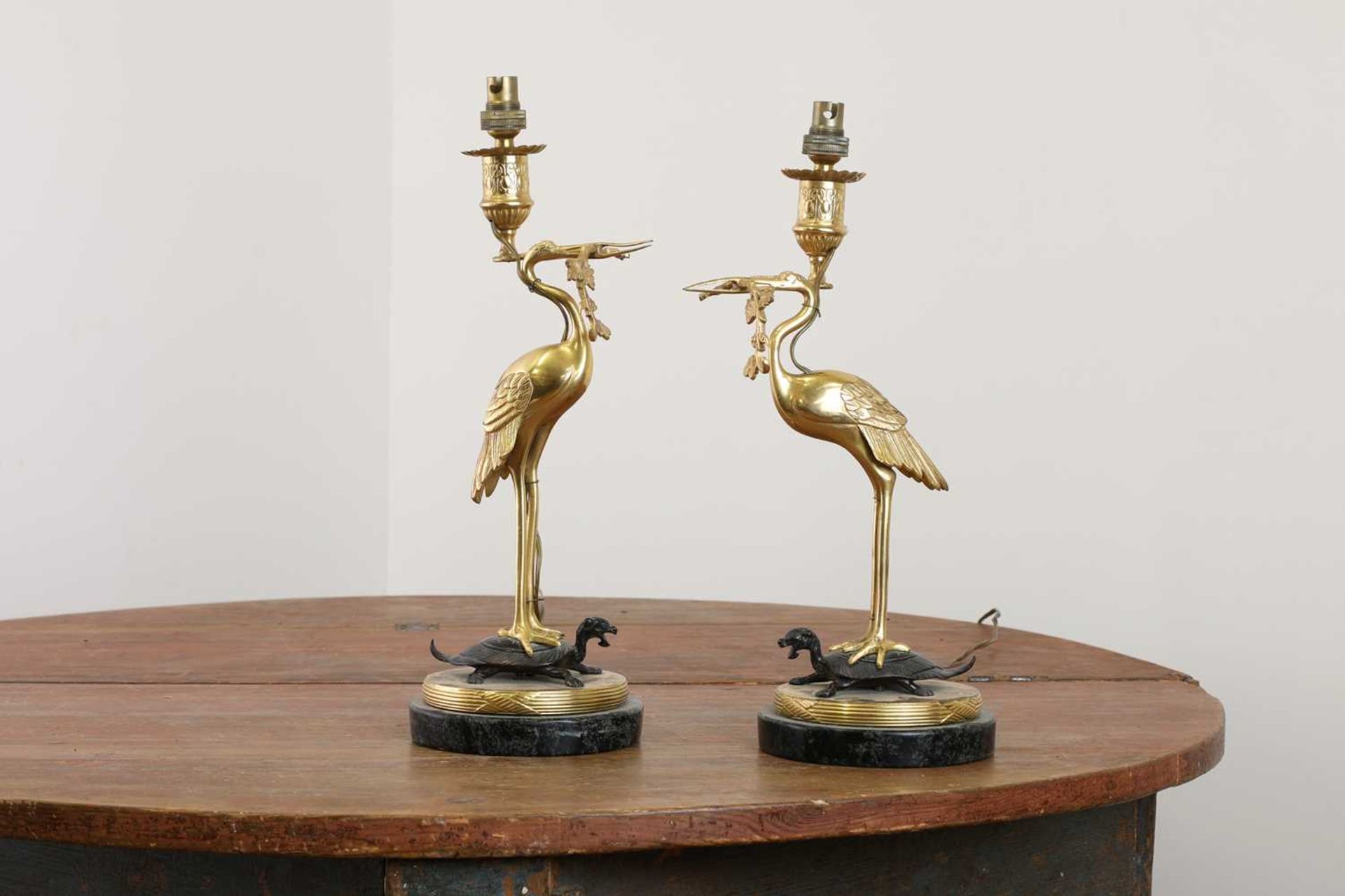 A pair of gilt and patinated bronze table lamps,