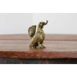 A bronze oil lamp in the form of a cockerel,