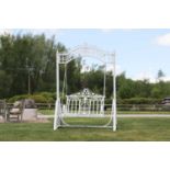 A painted ironwork garden swing seat,