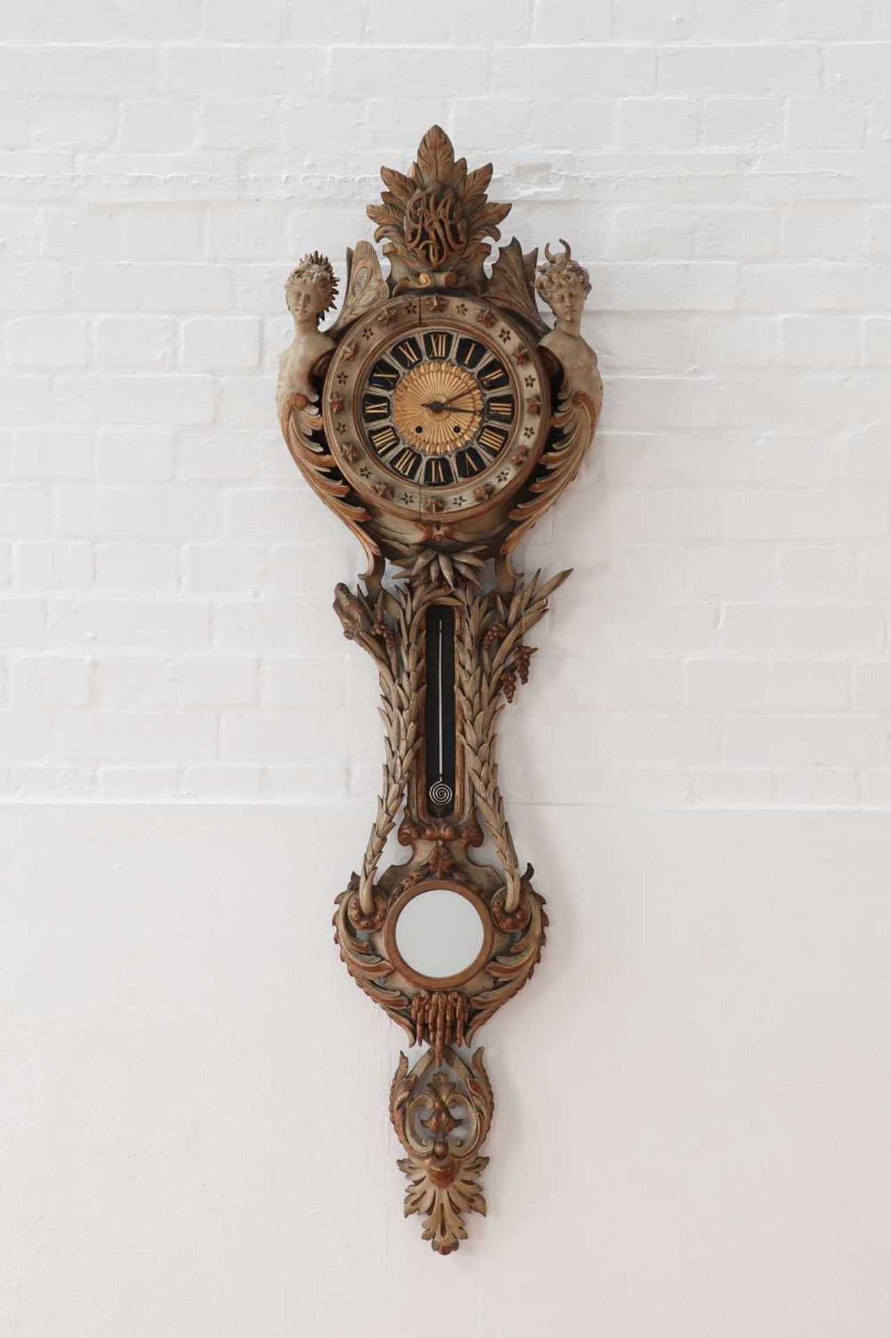 A Continental carved and painted softwood wall clock,