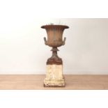 A cast iron urn and stand,