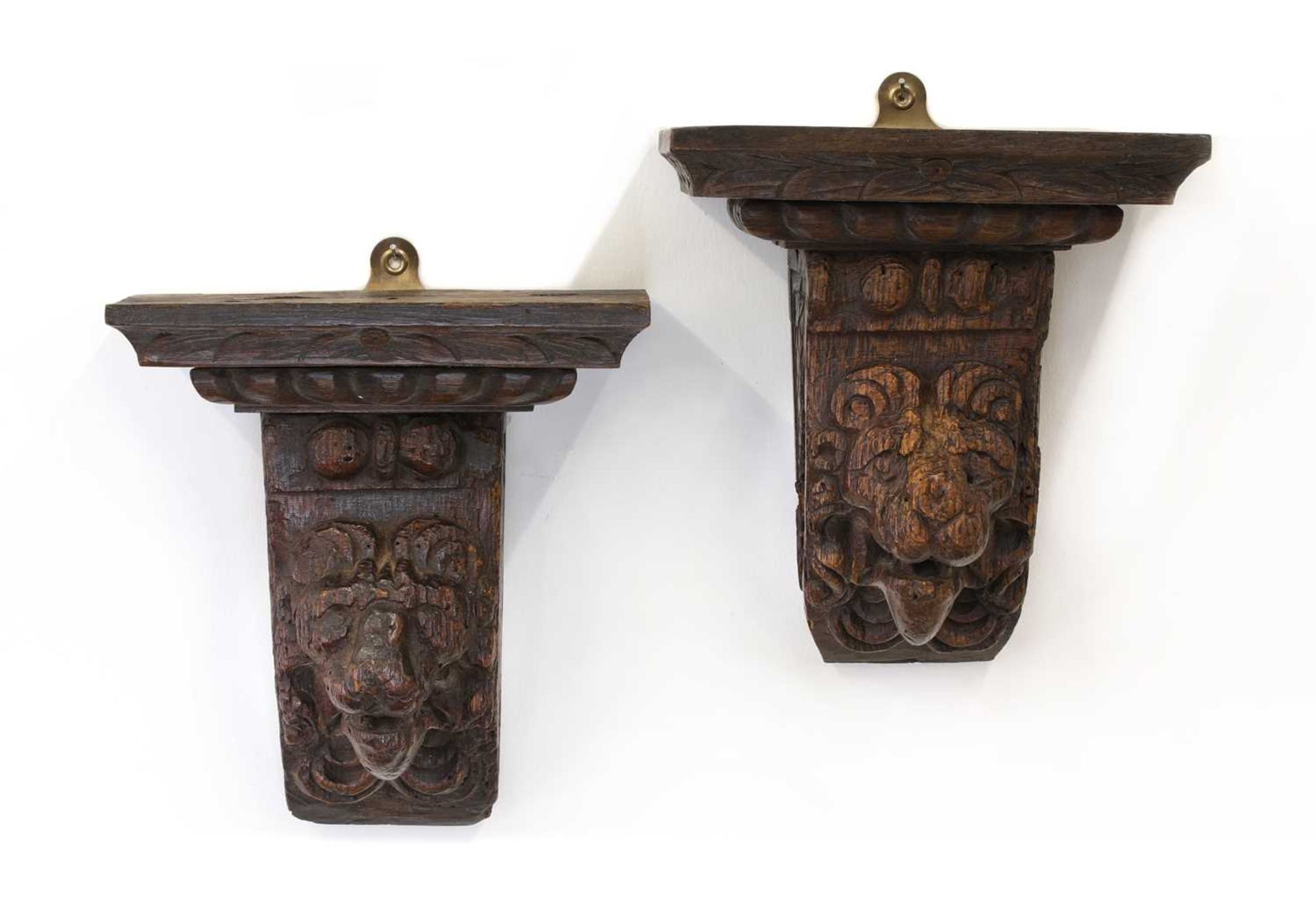 A pair of early lion mask carved oak corbels,