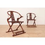 A pair of hardwood horseshoe-back folding chairs,