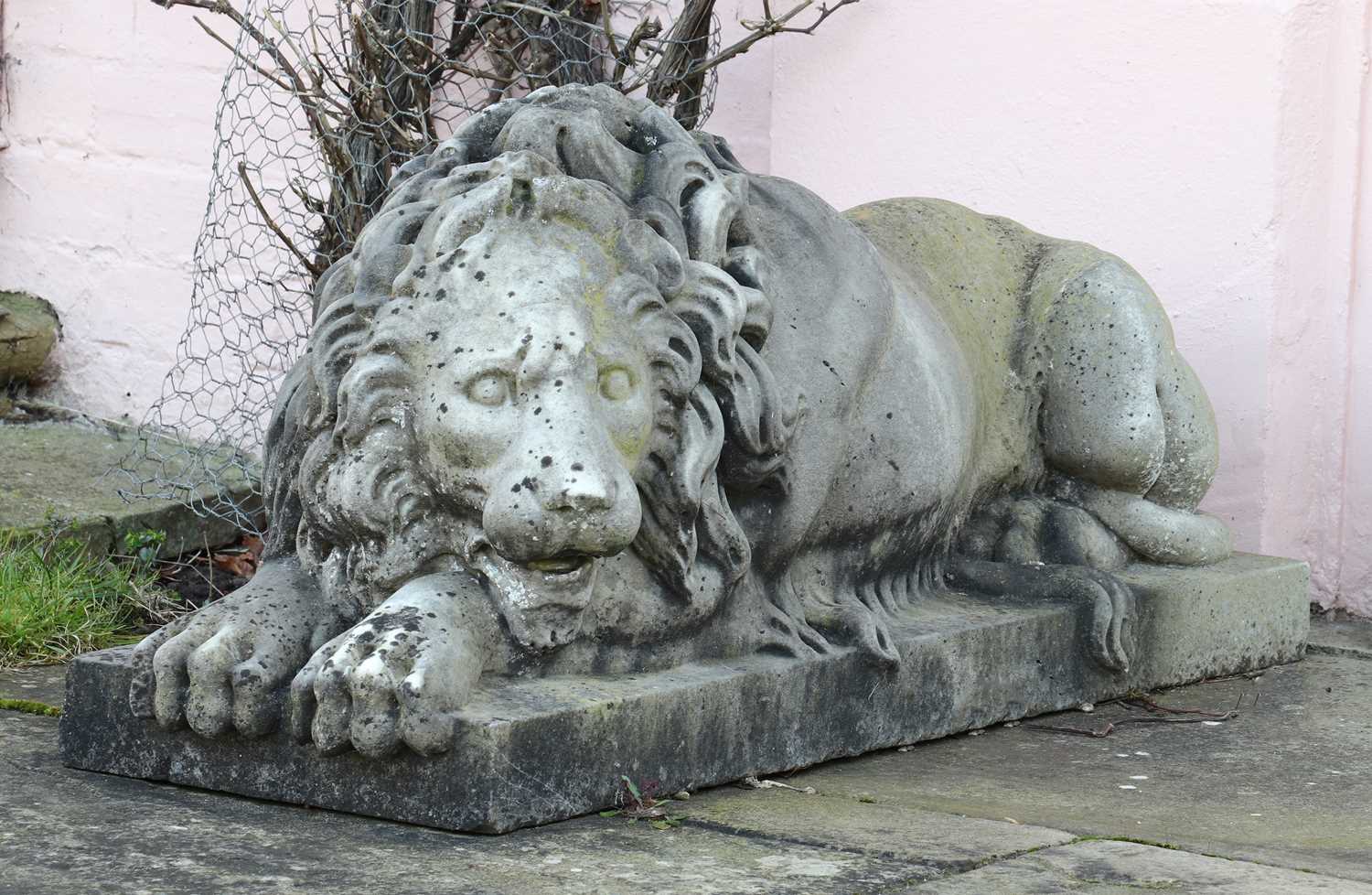 A pair of monumental marble lions on plinths,