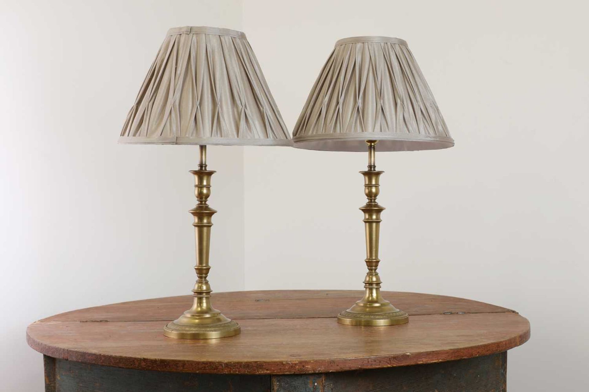 A pair of French Empire-style brass table lamps,