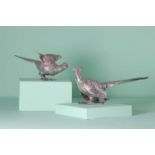 A pair of silver models of pheasants,