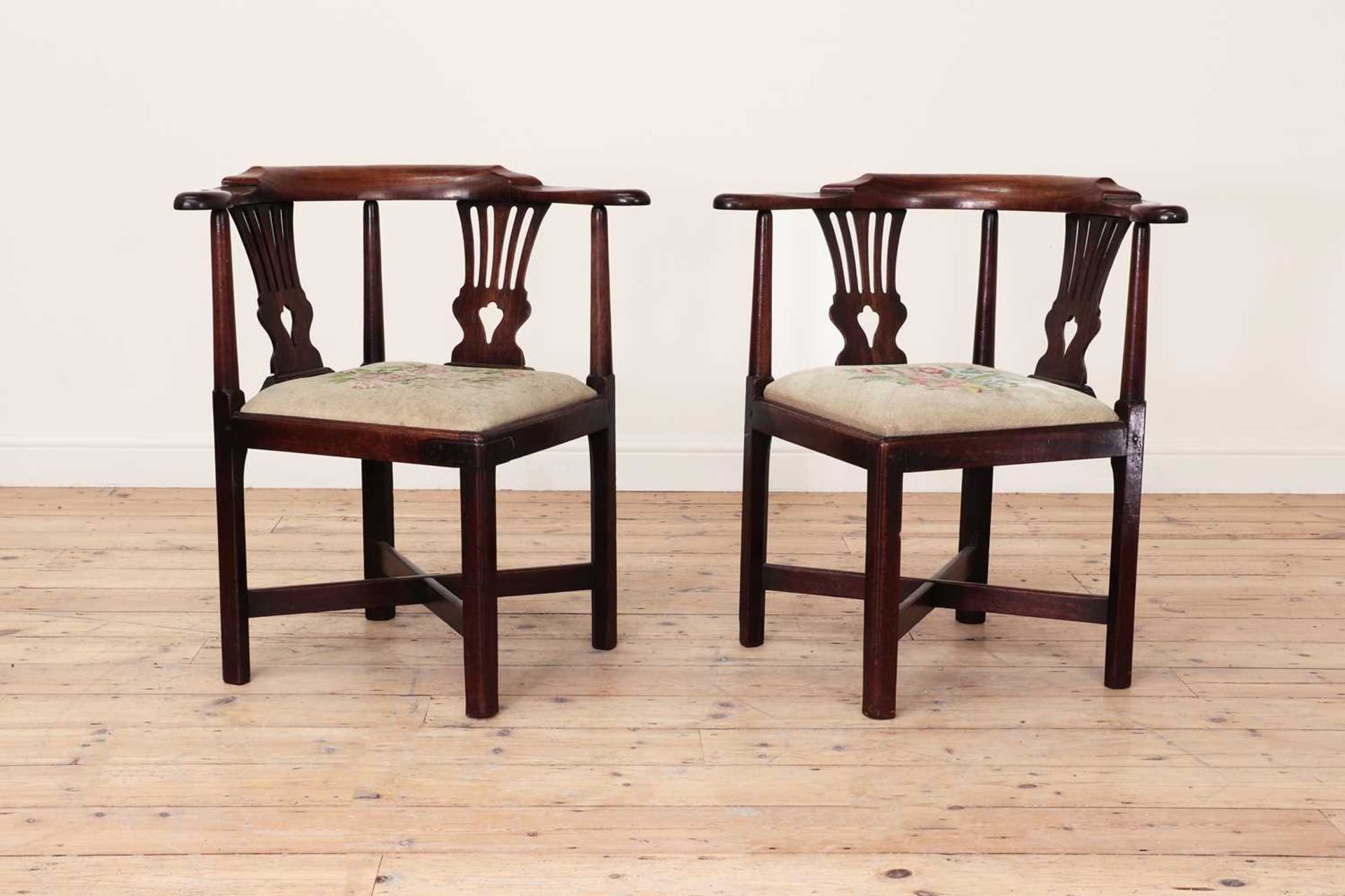 A pair of George III Chippendale period mahogany corner elbow chairs,
