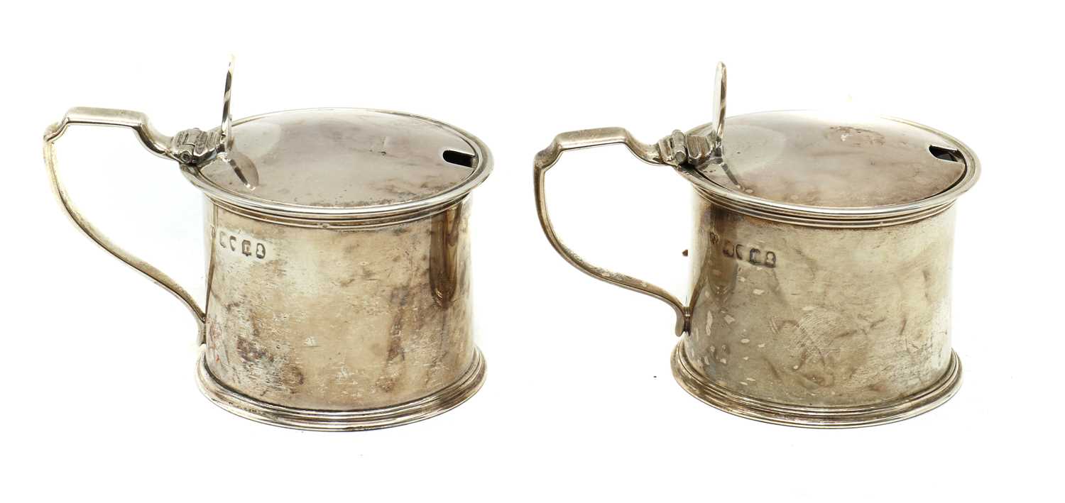 A pair of George III silver drum mustards pots