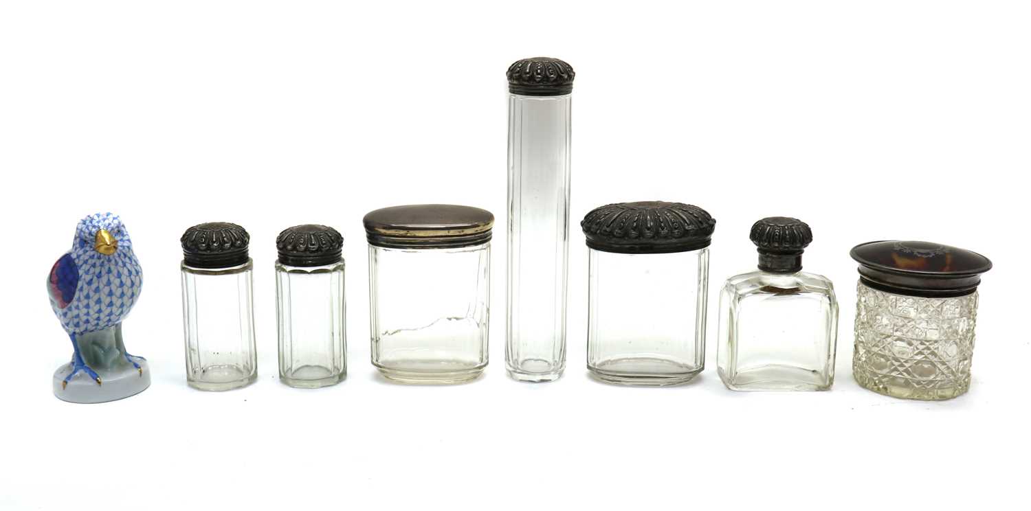 A collection of silver and cut glass dressing table jars,