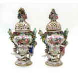 A near pair of Meissen pot pourri vases and covers