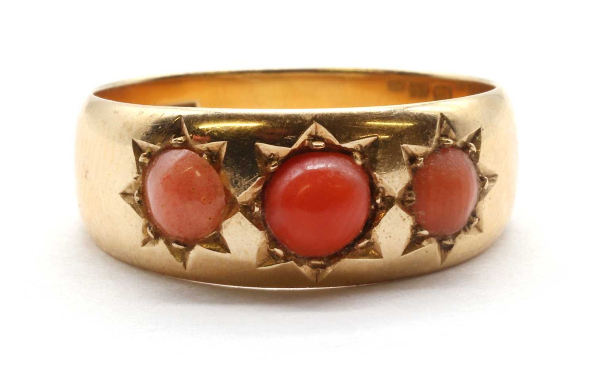 A gold three stone cabochon ring,