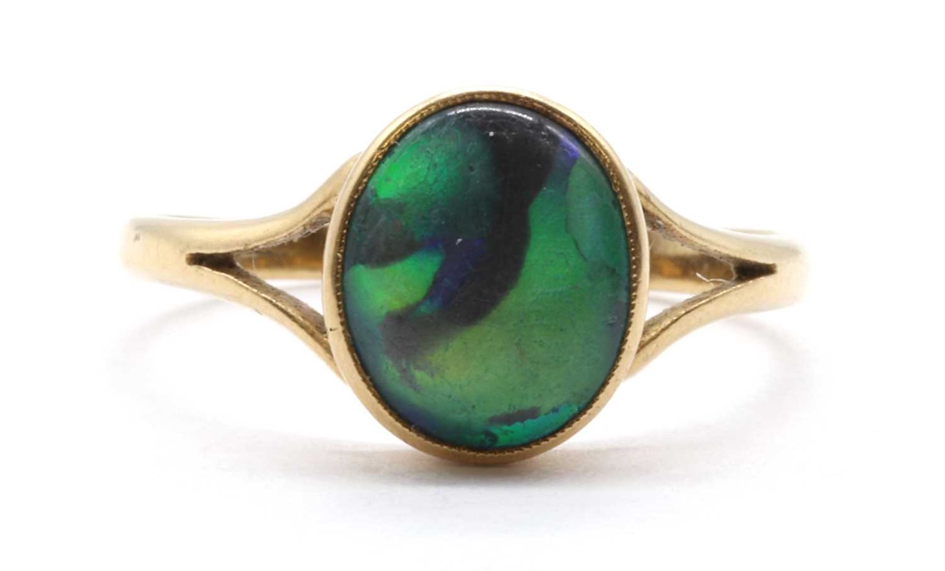 A gold single stone black opal ring,