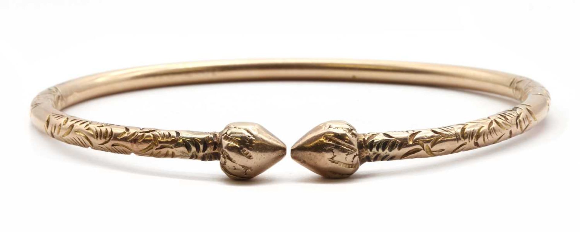 A gold torque bangle,