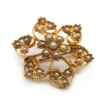 An Edwardian gold split pearl flower brooch/pendant,
