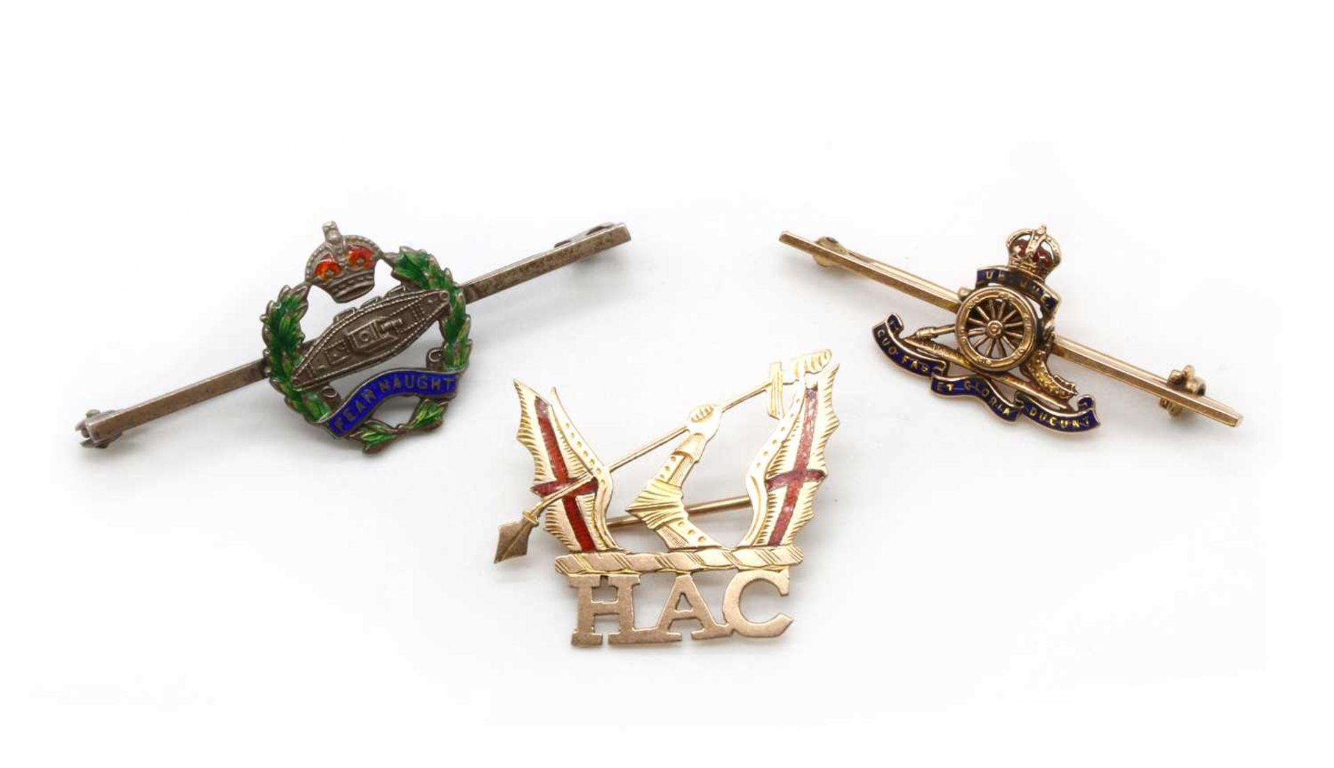A collection of military brooches and buttons,